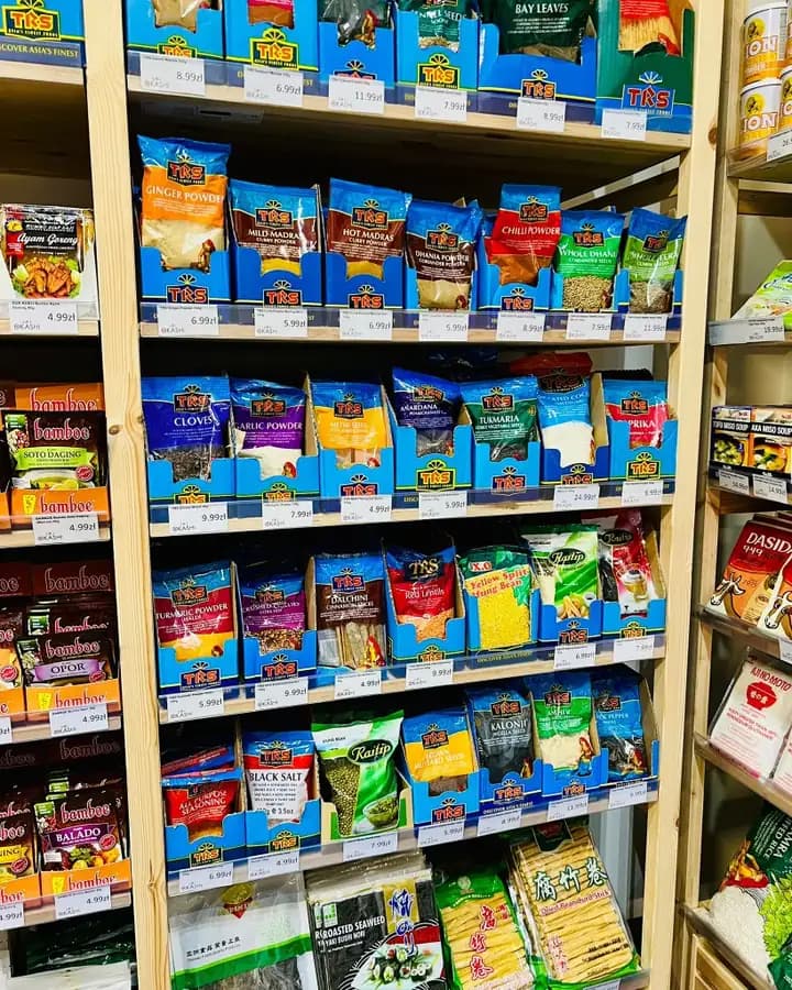 TRS spices, lentils and Asian pantry staples on wooden shelves at OKASHI Group