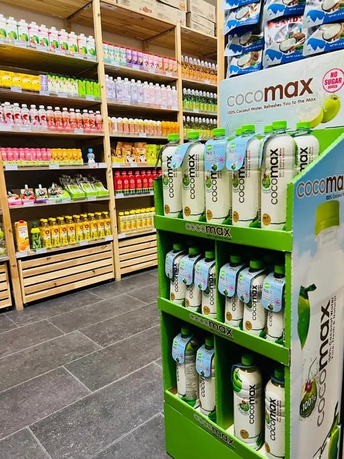 Cocomax coconut water floor display and bottled drinks aisle at OKASHI Wrocław