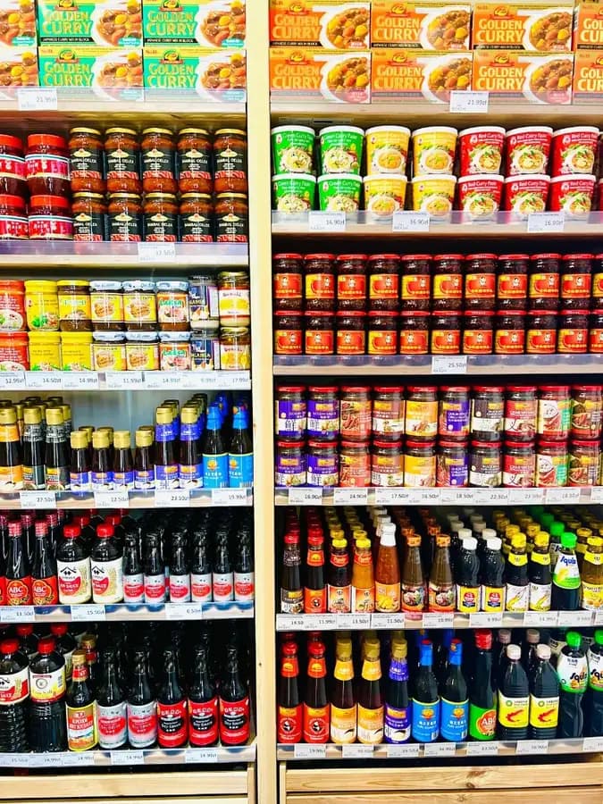 Japanese curry, Thai pastes and soy sauces in the condiment aisle at OKASHI Wrocław