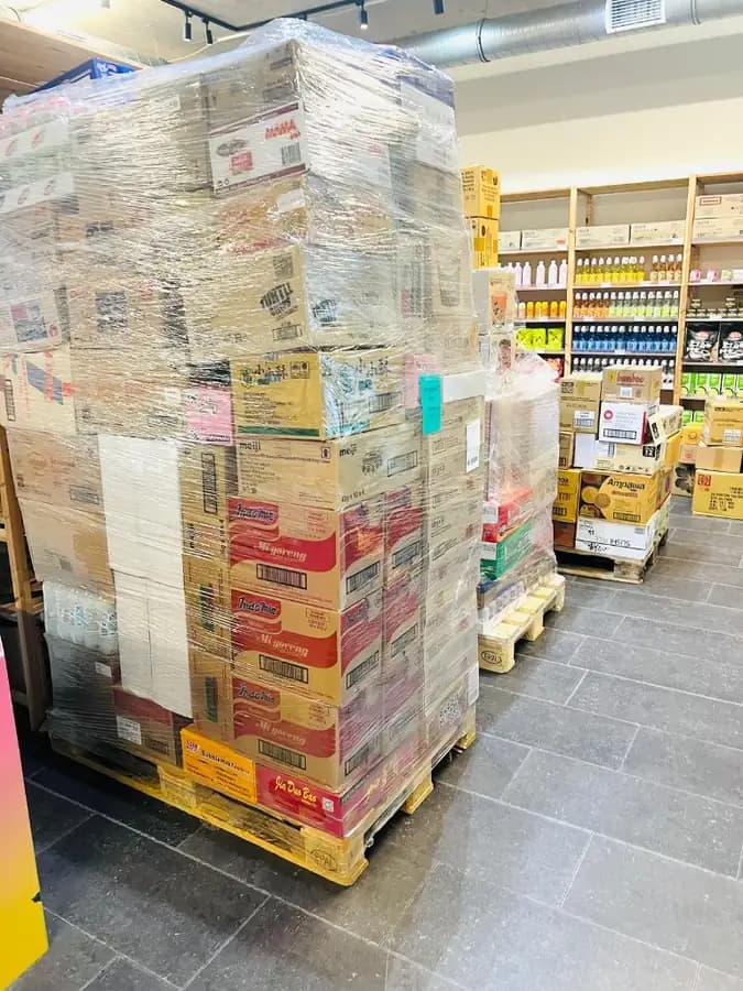 Wholesale pallet of Indomie, Meiji and Asian snacks arriving at the OKASHI Wrocław store